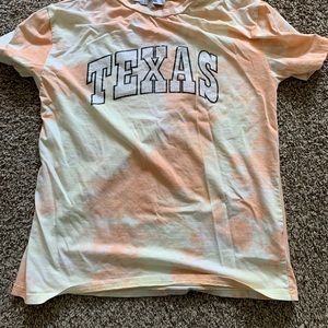 This shirt is by Adika and it’s yellow and orange.